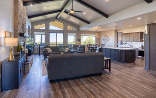 Spacious open-concept room with wood flooring, ample natural light, modern cabinetry, and inviting atmosphere in Show Low, AZ.