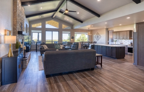 Spacious open-concept room with wood flooring, ample natural light, modern cabinetry, and inviting atmosphere in Show Low, AZ.