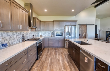 Modern kitchen in Show Low, AZ, with wood flooring, ample cabinetry, and a warm, inviting feel.