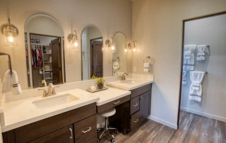 Modern bathroom with wood flooring and ample storage, exuding a warm, inviting feel. For sale in Show Low, Arizona.