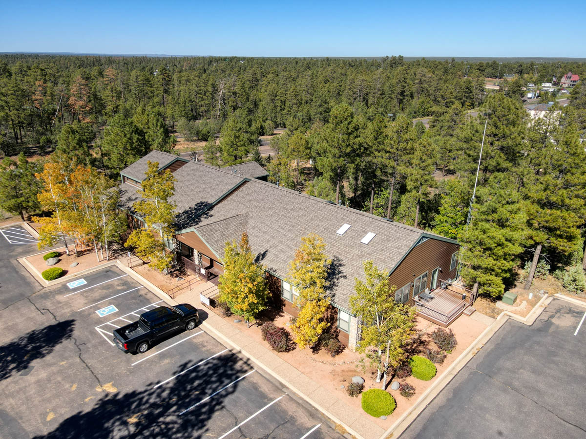 default Commercial building surrounded by trees with ample parking space, located in Show Low, Arizona.