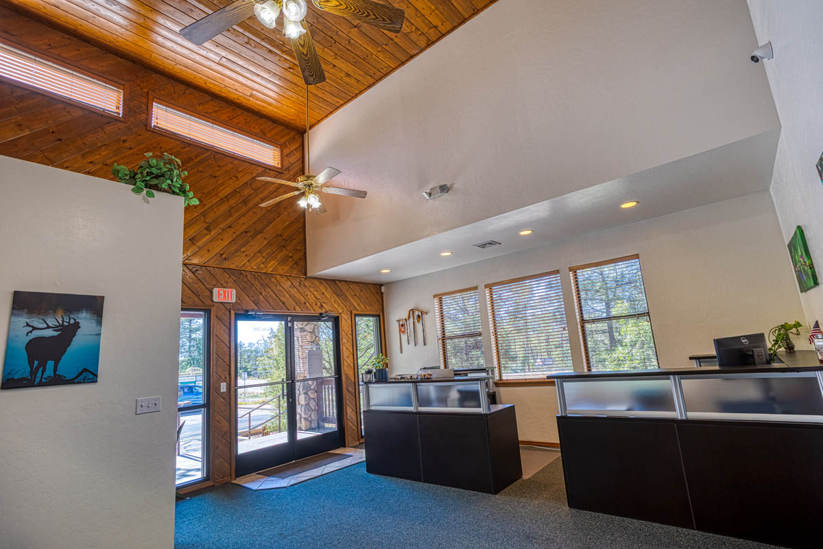 Showlow Office Buildings for Sale (3) Spacious office in Show Low, AZ with high wooden ceilings, carpet flooring, natural light, and a welcoming atmosphere.