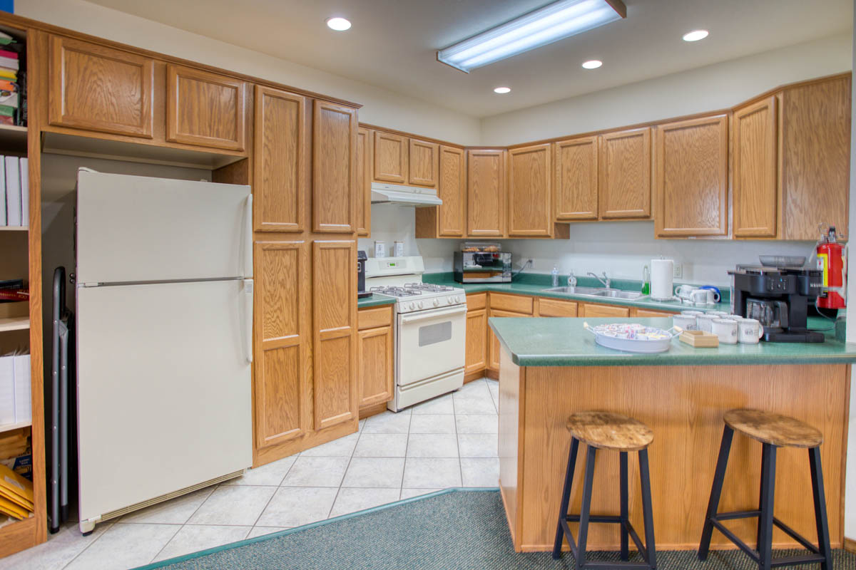 Showlow Office Buildings for Sale (7) Spacious kitchen with ample cabinetry, tile flooring, and cozy atmosphere. Ideal for sale in Show Low, Arizona.