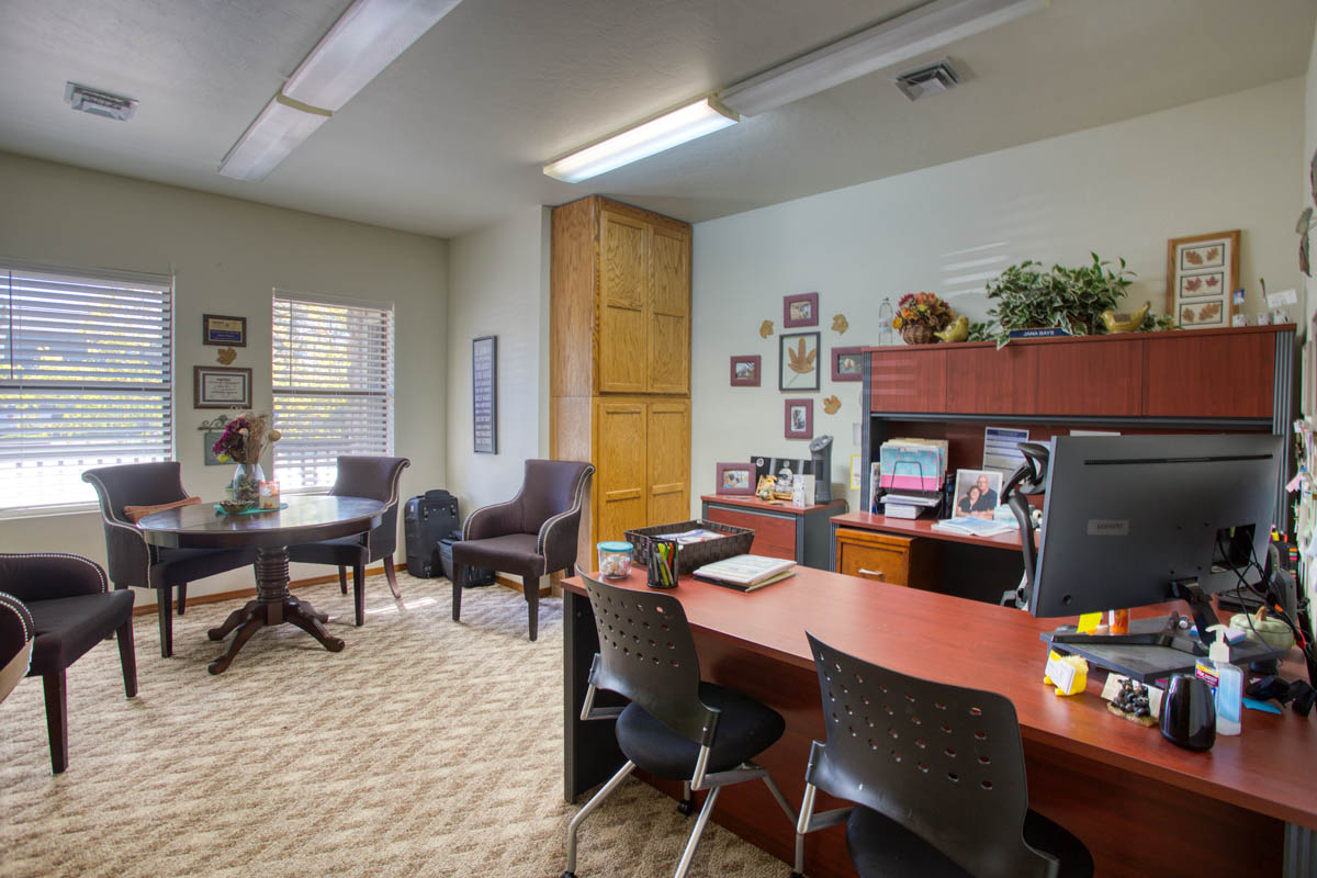 Showlow Office Buildings for Sale (8) Office space with carpet flooring, built-in wooden cabinets, and a warm, inviting atmosphere. For sale in Show Low, Arizona.